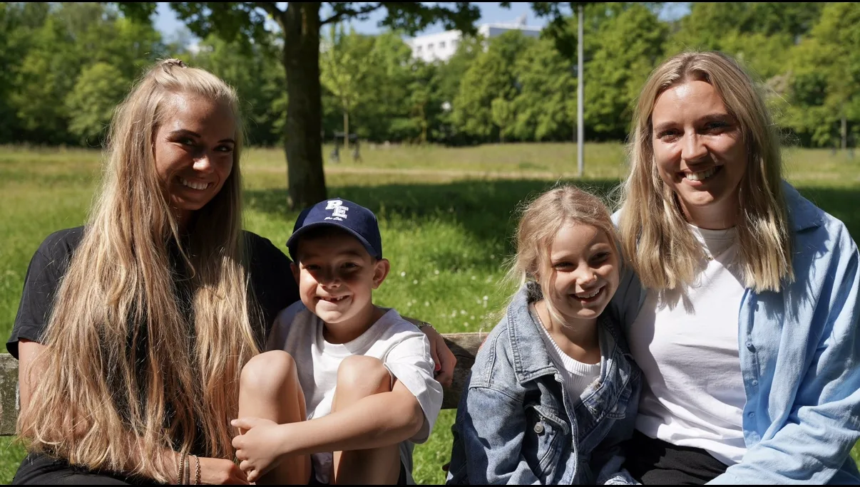 Aflastning – to voksne og to børn på bænk i park